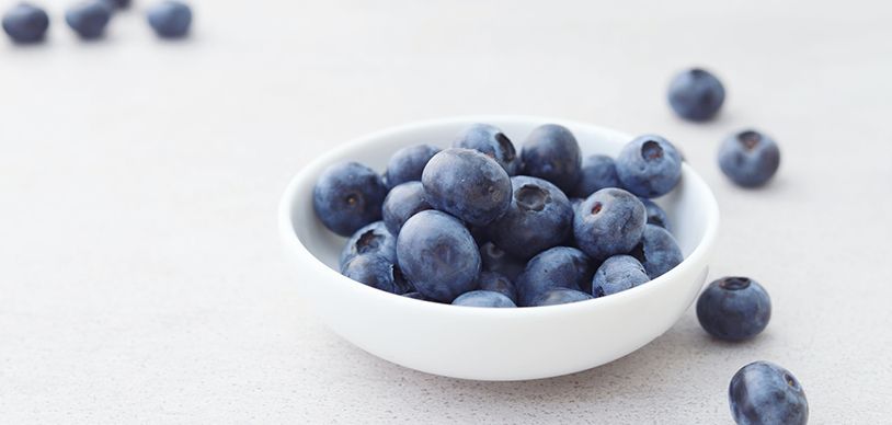 small white bowl filled with blueberries